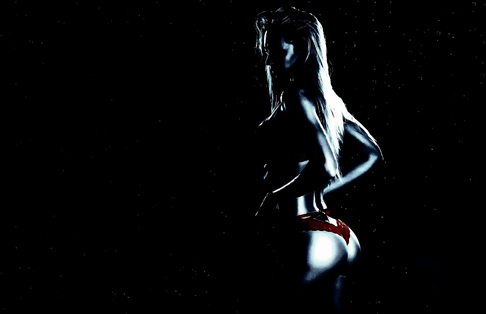 Rear view of a woman in a red bikini bottom