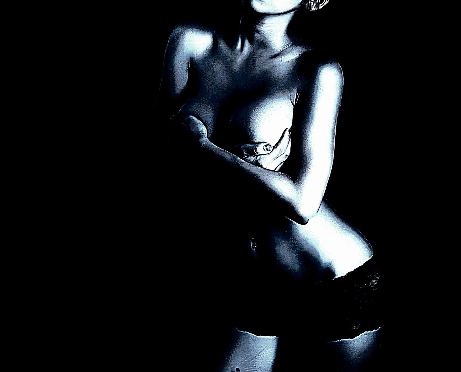 Mysterious close-up of a woman in shadows, arms crossed over her chest with a striking monochrome effect.