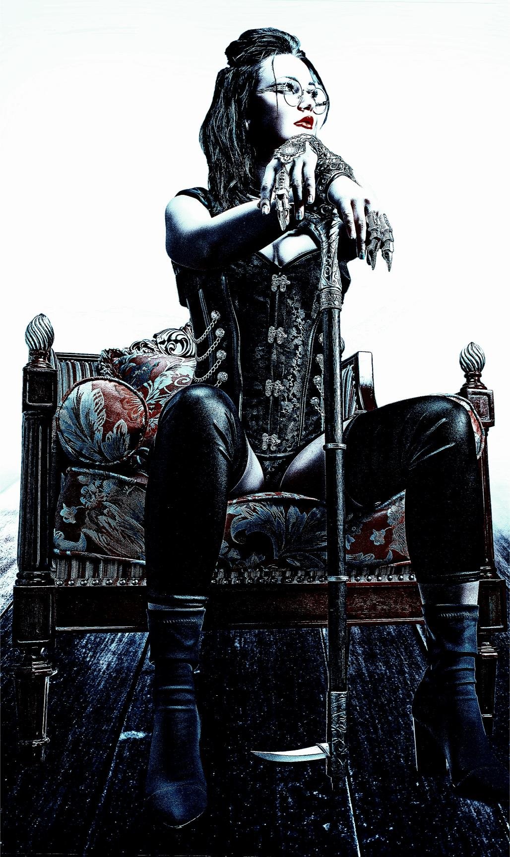 Woman in gothic corset sitting on a throne, holding a cane with an ornate handle, exuding power and confidence.