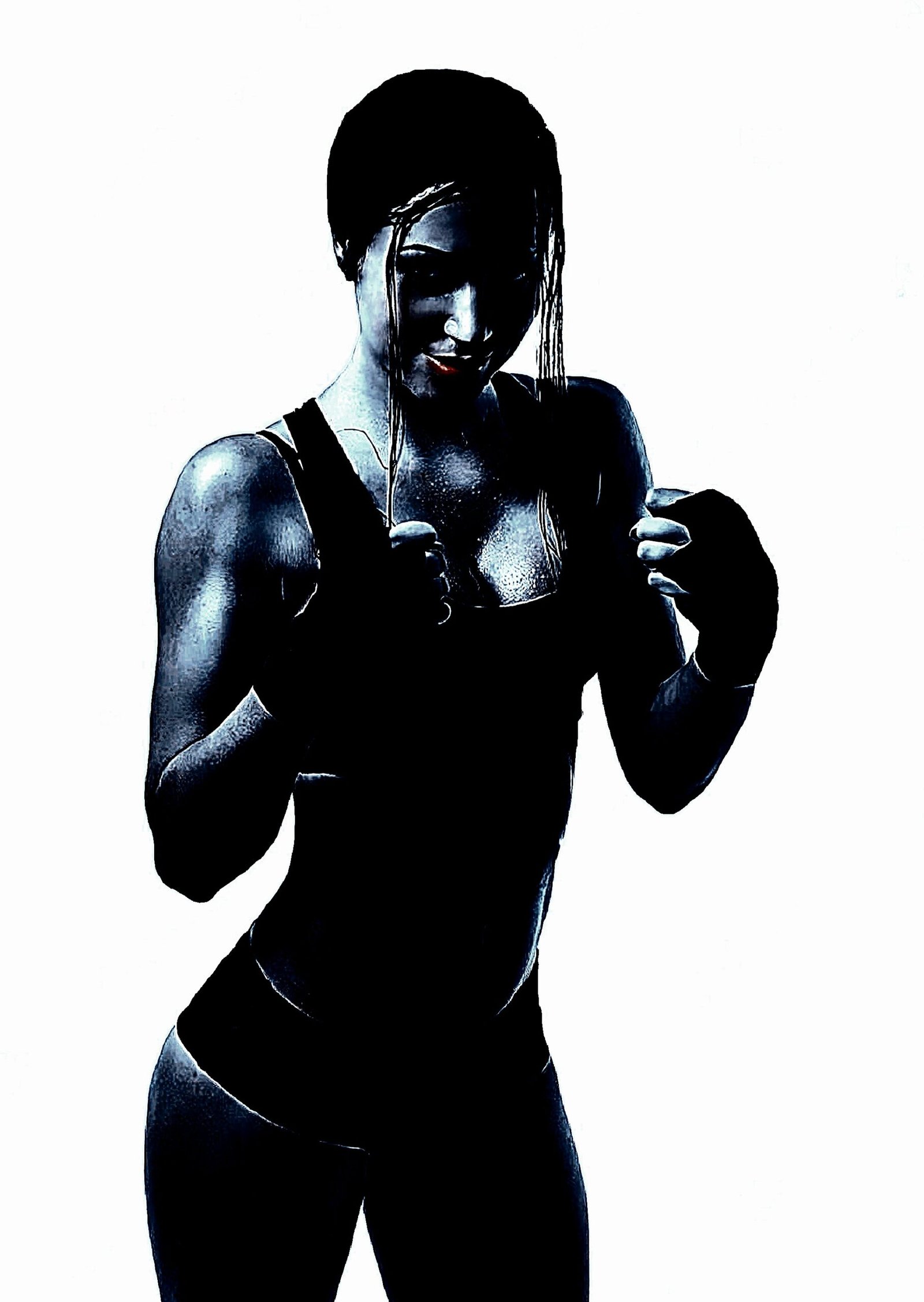 Fit woman in athletic gear, striking a confident pose with intense shadows and dramatic highlights.
