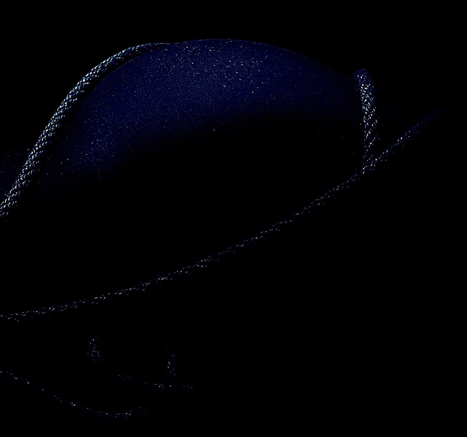 A close-up of a body wrapped in thick rope, shadows highlighting the texture.