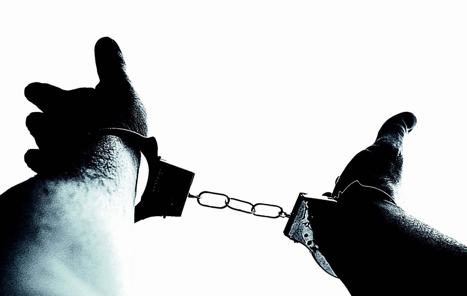 Outstretched hands locked in handcuffs, silhouetted against a bright white background.