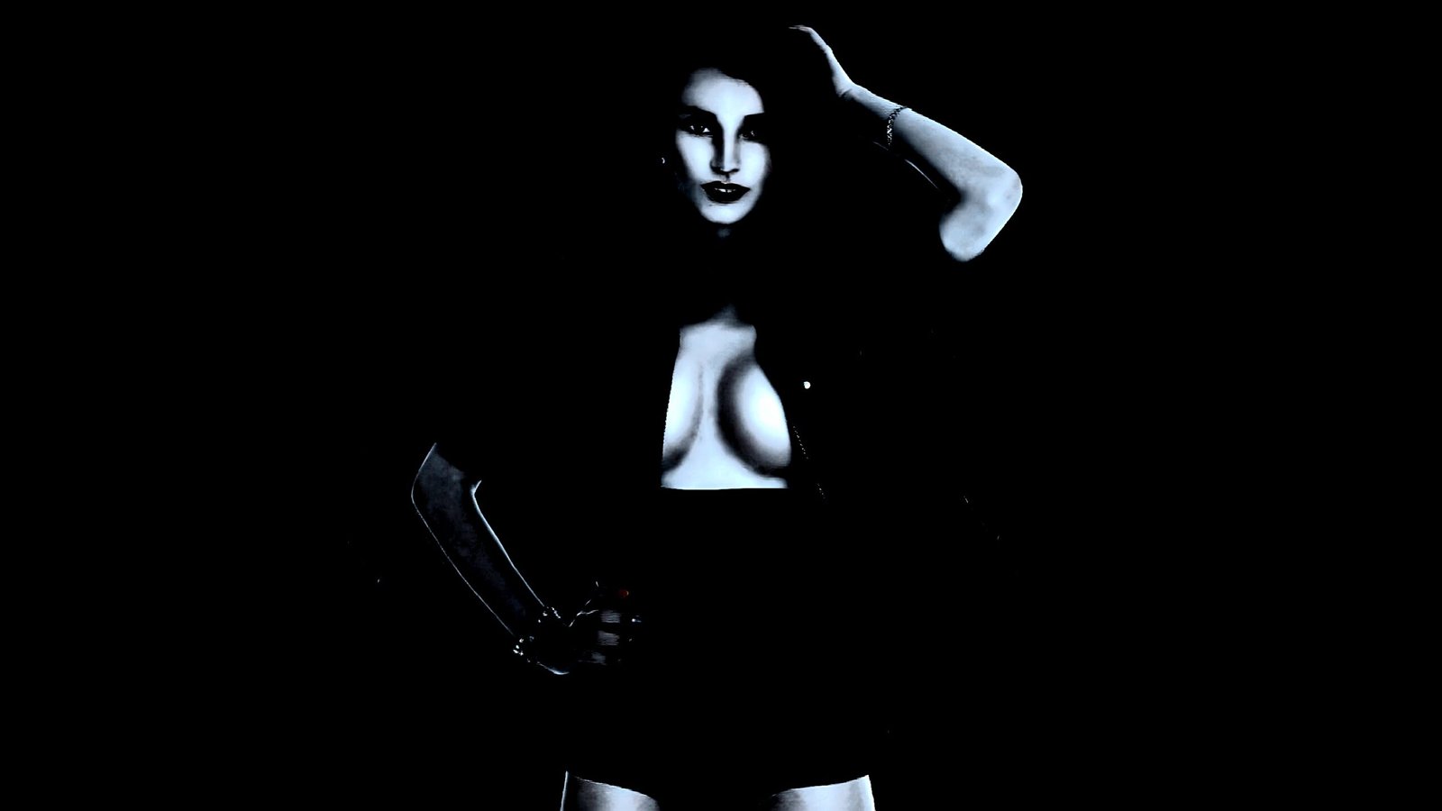 A confident woman in a dark outfit exposing her cleavage, standing in a powerful pose against a black background.