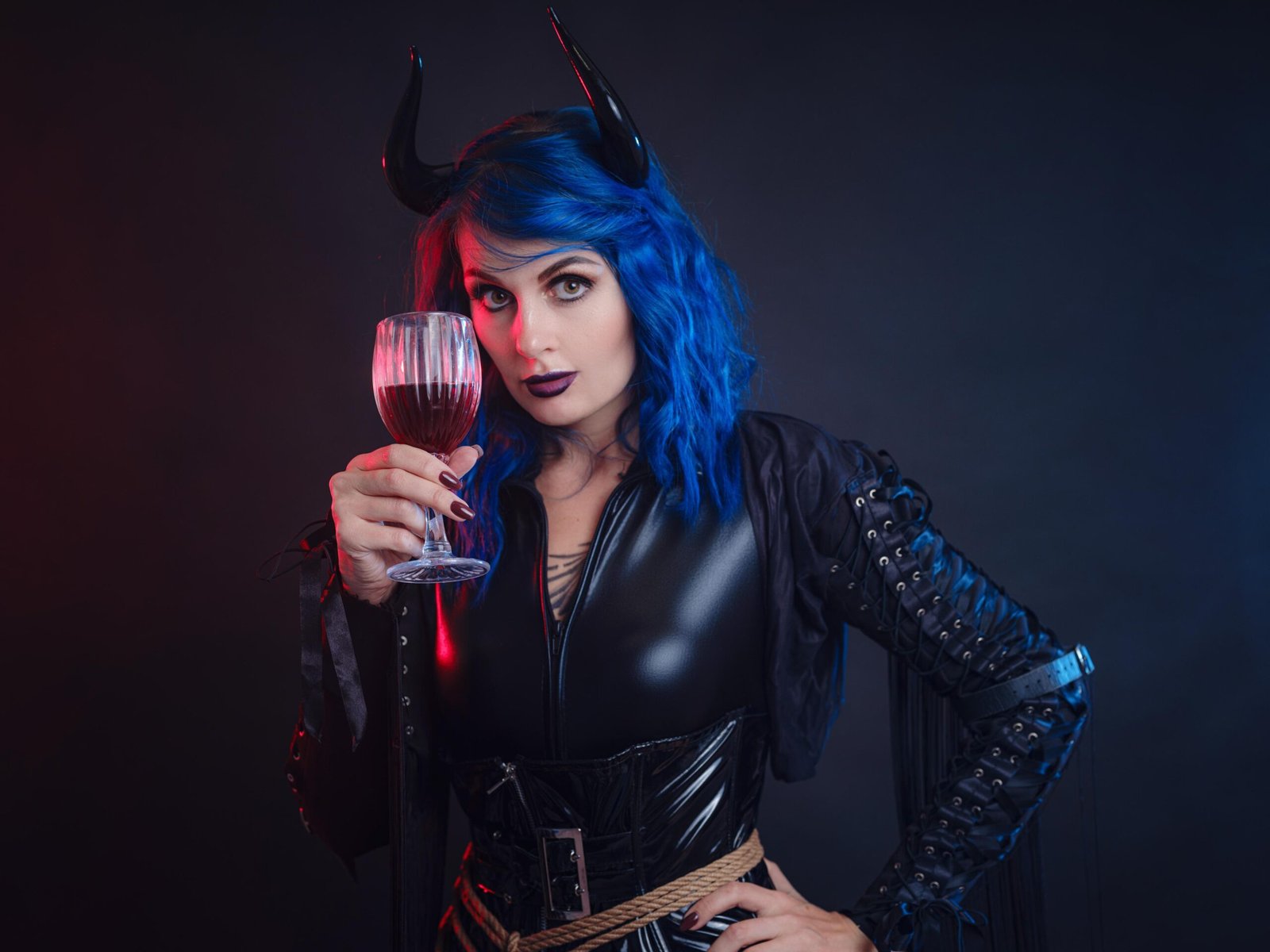 Blue-haired demon woman with horns holding a wine glass, gothic seduction