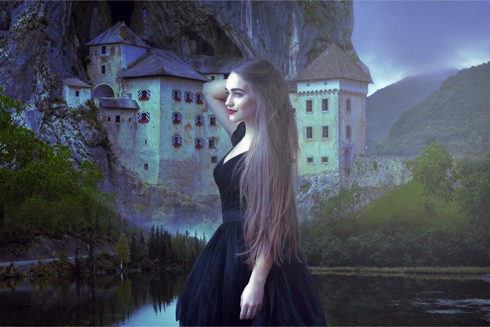 Woman with short dark hair, white blouse and corset sitting on grass, gothic choker necklace
