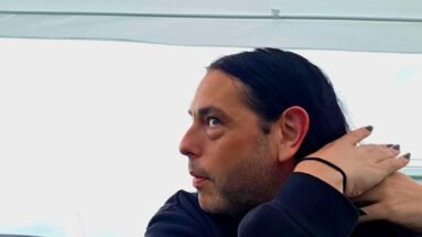 Xavi at Wacken Open Air 2025, side profile adjusting hair under a festival tent